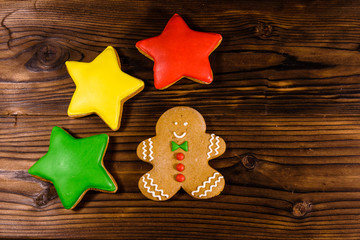 Christmas gingerbread man and stars on wooden table. Top view