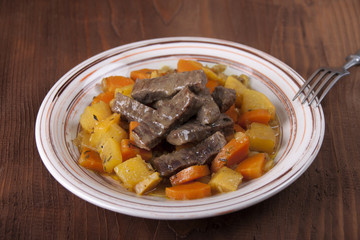 Beef with stewed vegetables in a plate