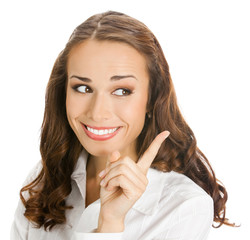 Fototapeta premium Happy smiling young business woman showing blank area for sign or copyspase, isolated on white background