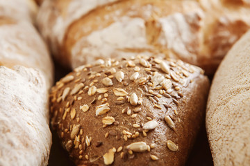 Bread background, closeup of white, whole grain and rye loaves
