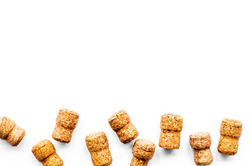 Wine bottle corks pattern on white background top view copyspace. New Year celebration concept