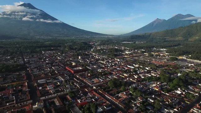 ANTIGUA GUATEMALA, GUATEMALA - OCTOBER 2016: The view over the city of Antigua Guatemala and the volcanos of Agua, Fuego and Acatanengo in the background in October 2016.
