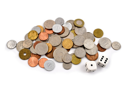 Coin stock images. 
Different coins on a white background. Different types of currencies. Money and dice