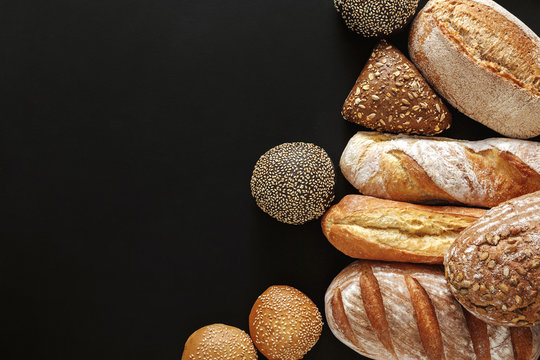 Bakery concept. Plenty of bread background isolated on balck