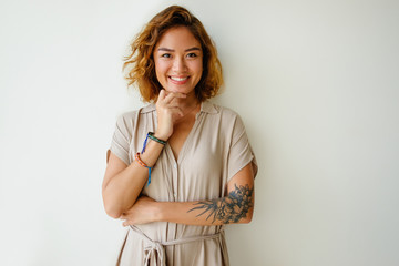 Portrait of happy young woman touching chin