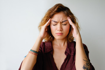 Naklejka premium Portrait of tired young woman having headache