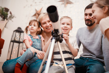 Image of happy family with telescope