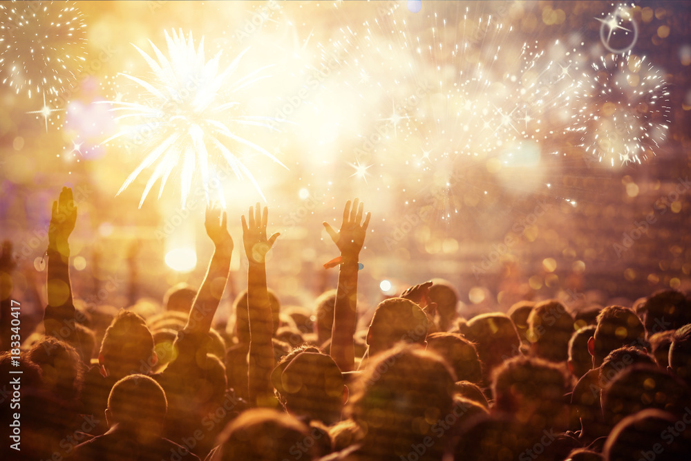 Wall mural cheering crowd watching fireworks - new year concept