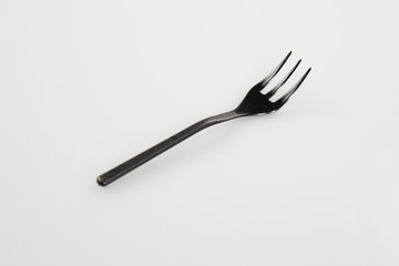 Conceptual image blackplastic fork in white background