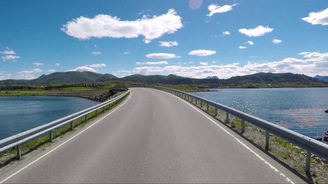 Driving a Car on a Road in Norway Atlantic Ocean Road or the Atlantic Road (Atlanterhavsveien) been awarded the title as (Norwegian Construction of the Century).