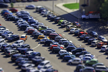 parking lot with many cars. there is no free parking space. urban landscape shot from high. large parking lot looking like a miniature. mini city. - Powered by Adobe