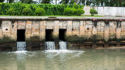 Water from a canal in the city is dropping down to the sea. To drain water and to prevent flooding...