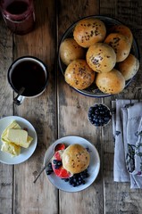 Homemade buns with linseed sunflower seeds for breakfast with butter and blueberry jam