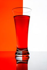 a glass of cranberry juice on a white background 
