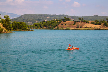 couple rowing in a boat on the lake