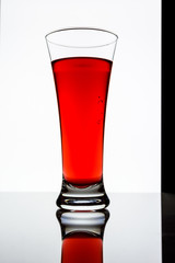 a glass of cranberry juice on a white background 