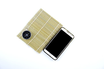 isolated phone,compass and bamboo mat in white back ground