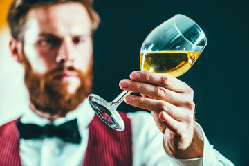 Sommelier examining white wine