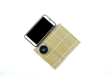 isolated phone,compass and bamboo mat in white back ground