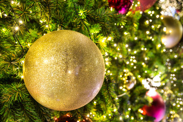 Decorative ball on christmas tree with blinking light