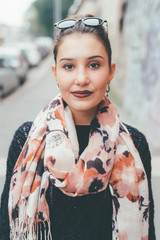 Fototapeta premium portrait of young woman outdoors looking camera smiling - happiness, serene, customer concept