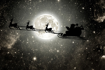 silhouette of a flying goth santa claus against the background of the night sky.  Elements of this image furnished by NASA