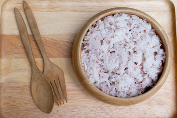 Bowl with brown rice on table