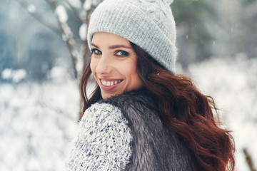 beautiful smiling young woman in wintertime outdoor. Winter concept