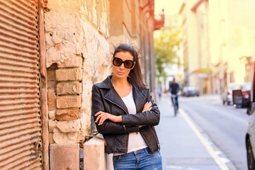 Obraz premium Fashion Portrait of a young woman in decayed European urban neig