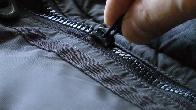 Video shows zipper closure on the blue jacket
