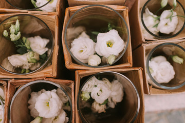 White beautiful roses in crystal vase placed in pepper boxes. Tender white flowers. Wedding decoration