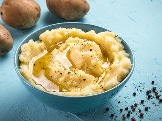 Mashed potatoes on blue concrete background