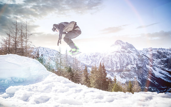 Snoboarder performing tricks on the snow