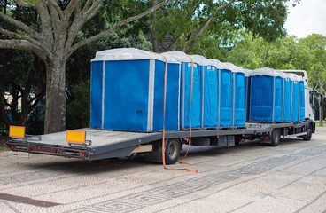 Portable bio-toilets on the truck. Preparing for the event. - obrazy, fototapety, plakaty