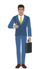 Businessman holding briefcase and showing thumb up