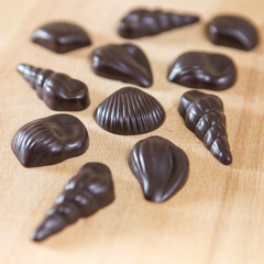 Homemade no sugar proper nutrition chocolate candies on a wooden background. Healthy food