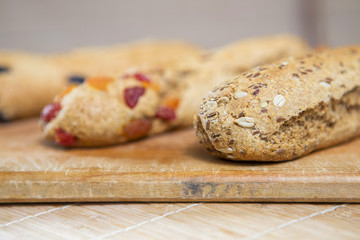 Homemade tasty biscotti with raisins and dried fruits. Italian traditional receipt. Healthy no sugar food. Wooden background