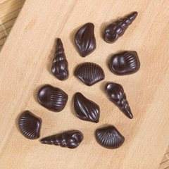 Homemade no sugar proper nutrition chocolate candies on a wooden background. Healthy food