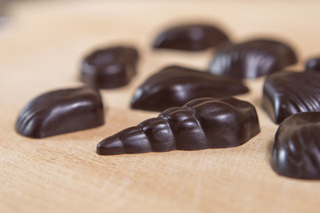 Homemade no sugar proper nutrition chocolate candies on a wooden background. Healthy food