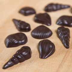 Homemade no sugar proper nutrition chocolate candies on a wooden background. Healthy food