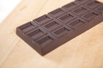 Homemade no sugar proper nutrition chocolate bar on a wooden background. Healthy food