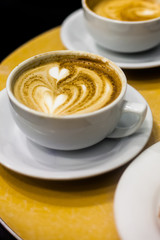Double heart-shaped coffee art on espresso beverage