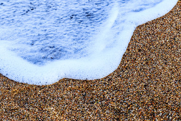 The Balearic sea in Spain. Soft Wave Of Blue Ocean On Sandy Beach. Background. Selective focus.Summer outdoor nature harmony. Summer holiday serenity.