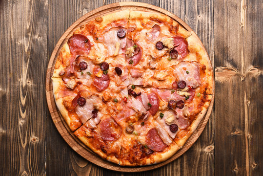 Italian dish on wooden tray. Pizza with bacon and cheese
