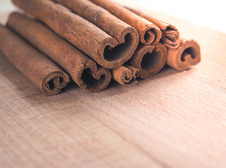 Cinnamon sticks on rustic wooden board

