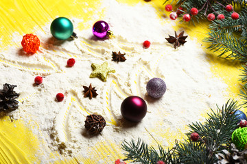 White tree with toys drawn on flour scattered on table