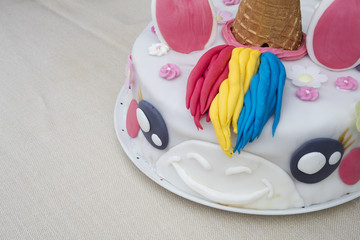 Homemade birthday cake unicorn on a table