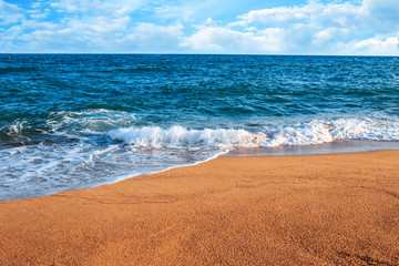 The Balearic sea in Spain. Soft Wave Of Blue Ocean On Sandy Beach. Background. Selective focus.Summer outdoor nature harmony. Summer holiday serenity.