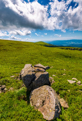 giant boulders on grassy slopes of Polonina Runa. beautiful summer scenery in Carpathian mountains with gorgeous cloudscape