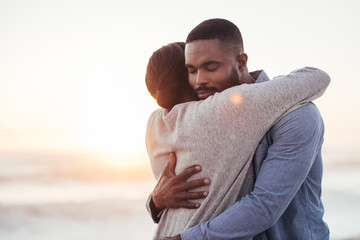 Content young African couple embracing each other at the beach - Powered by Adobe